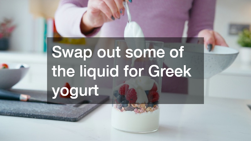 woman adding yogurt to her smoothie