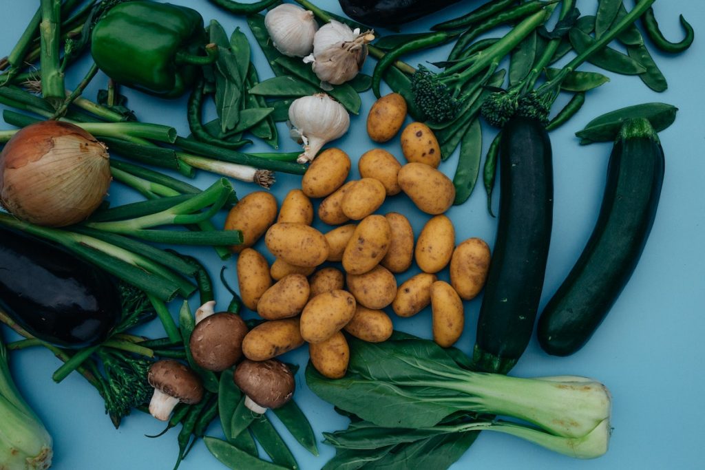 Close-Up Shot of Variety of Vegetables on a Blue Surface
